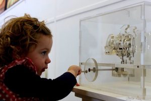 Kitty Tate operating a mechanism at the Christmas group show at the Outlaw Gallery