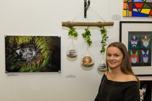 An artist at Warrnambool College's '23 Visions' group show at the Outlaw Gallery