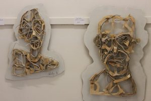 Two wood and wire portraits at the 'Just Tuesdays' group show at the Outlaw Gallery