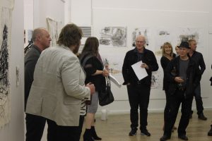 A crowd of people at the 'War and Stitch' exhibition launch