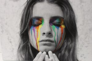 A portrait of a girl crying multicoloured tears